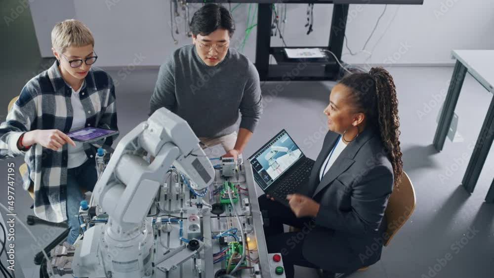 Aufkleber Black Teacher Explaining Information to Students Gathering Around Table with Robot Limb. People Holding Devices with Apps and Discussing It at University. Education Concept. High Angle View