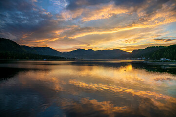 Reflections of sunset and clouds on a lake