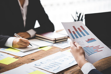 Teamwork with price chart analyzes business people on the table at the conference room.