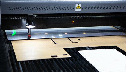 Digital die cutter machine cutting plastic acrylic. Industrial manufacture.