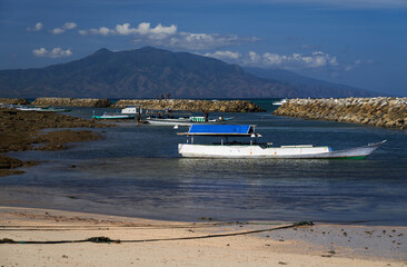 Beach with fishing boat in Asia. Sikka Regency, East Nusa Tenggara, Flores, Indonesia.