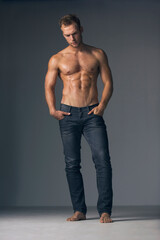 Brooding masuclinity. Studio shot of a shirtless muscular man wearing jeans.