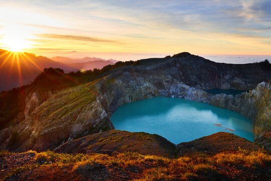 Sunrise and crater lake at Kelimutu volcano. Ende Regency, East Nusa Tenggara, Flores, Indonesia, Asia. Travel photo.