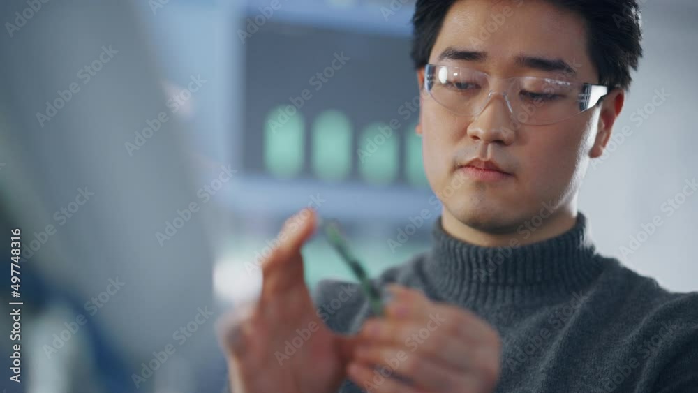 Aufkleber Asian Student Considering Fee and Takes Out Memory Card while Working on Project at University. Modern Technologies, Science and Developing Concept. Close Up View