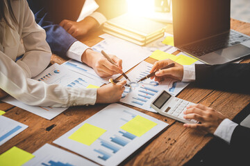 Teamwork with price chart analyzes business people on the table at the conference room.