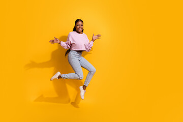 Fototapeta na wymiar Full length photo of overjoyed cheerful girl raise arms palms isolated on yellow color background