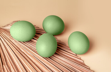 Green dyed Easter eggs on beige background. Tradition of Christian feast celebration. Natural farm eco-friendly food. High quality photo