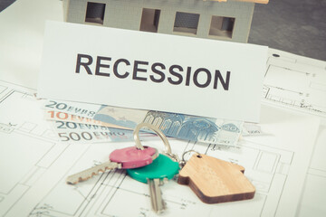 Keys of home, euro and inscription recession on housing plan. Real estate crisis caused by...