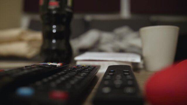 A tiny pet gerbil explores its surroundings on a coffee table.