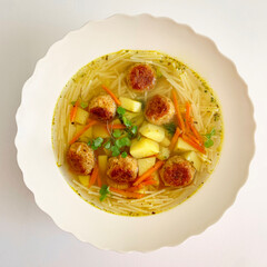 Vegetarian vegetable soup with lentil meatballs - 497750560