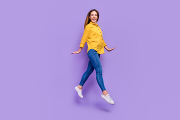 Fototapeta na wymiar Full size profile side photo of cheerful pretty girl have fun jumping relax during summer holiday isolated on violet color background