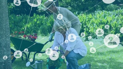 Network of profile icons against caucasian senior couple gardening together in the garden