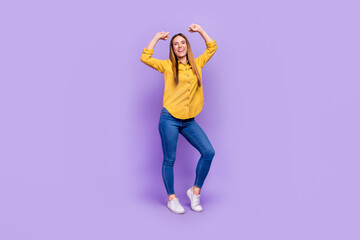 Fototapeta na wymiar Full body photo of overjoyed energetic lady dancing raise fists celebrate her victory isolated on violet color background