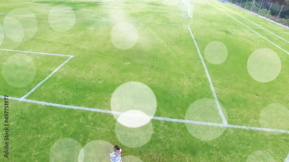 Wall mural Animation of light spots over diverse schoolchildren running at stadium