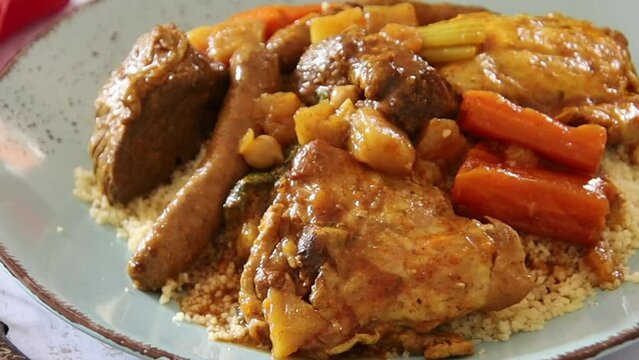 view of a royal couscous composed of chicken, lamb, merguez on a plate