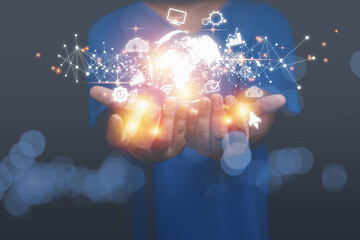 A man holding virtual world have internet network online, and business icons with copy space black background. Technology information and transformation business concept.