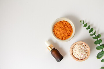 Natural ingredients for homemade face mask, top view of oil, oat and turmeric on white background, beauty skincare product concept, flat lay