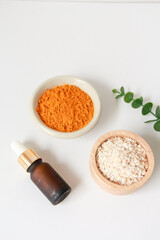 Natural ingredients for homemade face mask, top view of oil, oat and turmeric on white background, beauty skincare product concept, flat lay