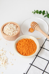 Natural ingredients for homemade face mask, top view of honey, oat and turmeric on white background, beauty skincare product concept, flat lay