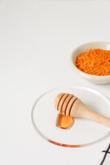 Natural ingredients for homemade face mask, top view of turmeric and honey on white background, beauty skincare product concept, flat lay