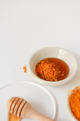 Natural ingredients for homemade face mask, top view of turmeric and honey on white background, beauty skincare product concept, flat lay