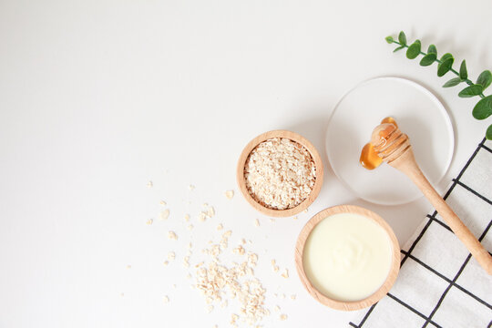 Natural Ingredients For Homemade Face Mask, Top View Of Yoghurt, Oat And Honey On White Background, Beauty Skincare Product Concept, Flat Lay