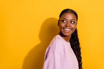 Obraz na płótnie Canvas Profile portrait of pretty satisfied person look interested empty space beaming smile isolated on yellow color background