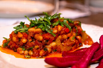 Stewed spiced white beans with tomato sauce