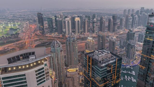 Panorama of Dubai Marina with JLT skyscrapers day to night timelapse, Dubai, United Arab Emirates.