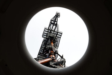 Historic blast furnace tower of ancient steel mill in Esch sur Alzette Luxemburg seen through a...