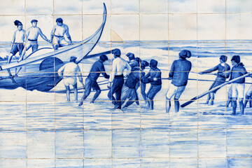 typical blue azulejos tiles which tells a story of life on the facade of the old railways station which tells a story of life in Aveiro, Portugal