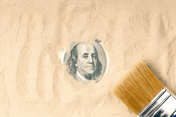 sand cleaning brush, one hundred dollars dug out of the sand. The president's portrait peeps out of...