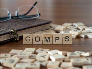 the acronym comps for comparable company analysis word or concept represented by wooden letter tiles on a wooden table with glasses and a book - obrazy, fototapety, plakaty