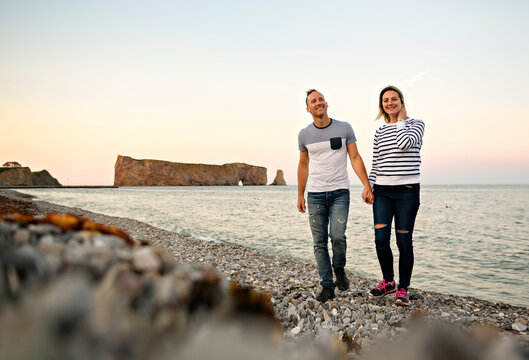 tourist couple enjoying Perce Rock view from Gaspe in Quebec