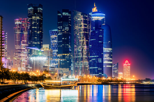 Night view on the centre of the city Doha, Qatar and the Gulf. Many modern luxury building and skyscrapers illuminated with numerous lights.
