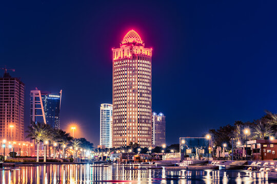 Iconic Ooredoo Tower in West bay Doha City at night with numeros lights