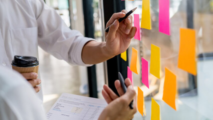 Start up partners are working in casual clothes, discussing the ideas for new strategy of development.