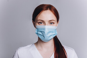 Woman doctor in medical mask on isolated background. Protection, epidemic, medicine, health care lifestyle concept