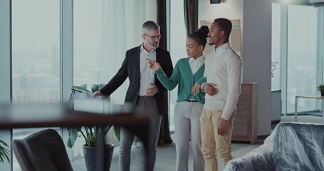 African american couple visiting new home talking to rela estate agent adult communicating about moivng in showing modern apartment.
