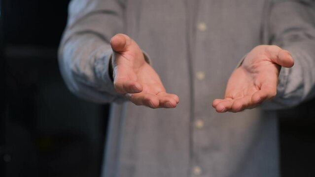 Shaking palms of a man suffering from essential tremor close-up.Parkinson's disease.