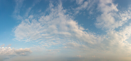Fantastic clouds against blue sky, panorama