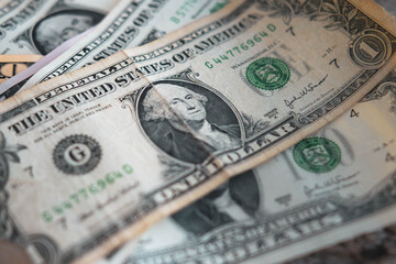 One dollar bill on old wooden table. Money, US dollar bills background. Money scattered on the desk. Photography for Finance and Economy concepts.