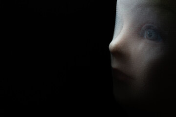 A girl doll isolated on black background with copy space.