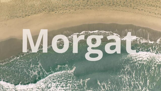 Morgat word being revealed with the shadow of a flying airplane on the beach
