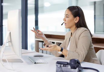 Ill have that corrected for you right away. Shot of a young woman using a headset and computer in a modern office.