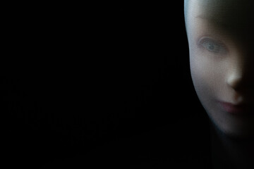A girl doll isolated on black background with copy space.
