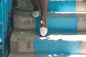 Fototapeta na wymiar the young woman on the blue stairs