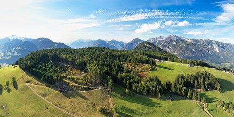Aerial panorama of an alpine landscape in summer, with mountain meadows and green woods. Hiking vacation at Alpbach and Inntal valley in Tyrol, Austria.