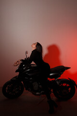 teen leisure. young brunette girl with long legs sits fashion on a black sports  motorcycle with...