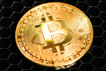 Golden bitcoin on a grid close-up. Crypto currency. Bitcoin mining concept